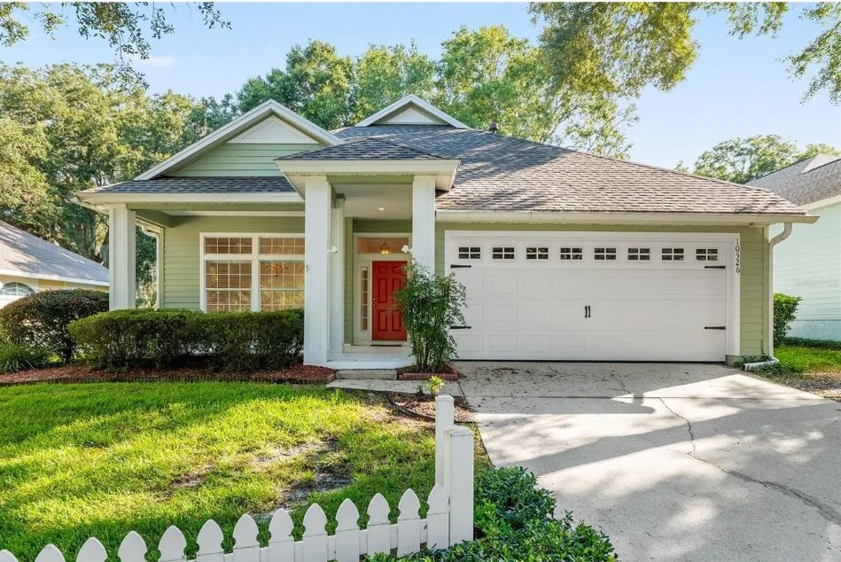 Green Craftsman Bungalow with Picket Fence in Gainesville, Florida