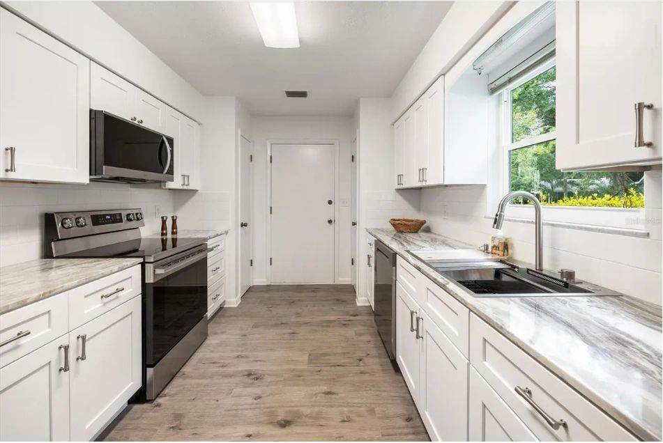 Gray Home with Renovated Kitchen and Stacked-Stone Fireplace, interior or exterior detail view